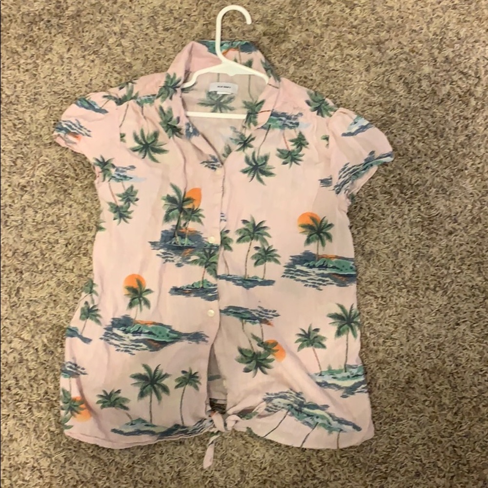 A button up pink Hawaiian pattern shirt